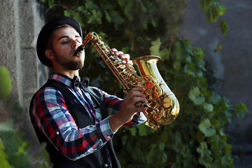 Man with saxophone outside at night