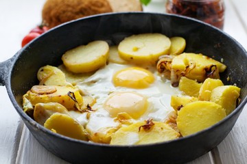 Fried potatoes with fried eggs, breakfast