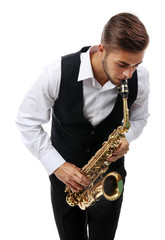 Naklejka premium Happy saxophonist plays music on sax in elegant suit on white background