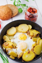 Fried potatoes with fried eggs, breakfast