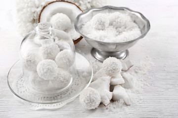 Homemade Candies in coconut flakes and fresh coconut on light background