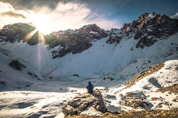 Man sitting in font of a frozen lake