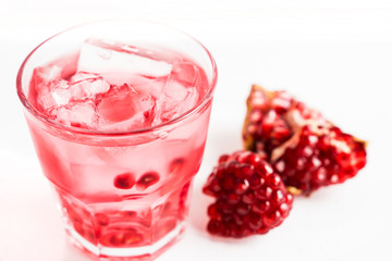 Delicious pomegranate cocktail on the wooden background