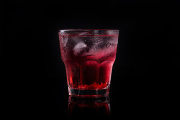 Delicious pomegranate cocktail on the black background