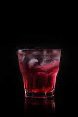 Delicious pomegranate cocktail on the black background
