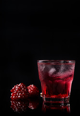 Delicious pomegranate cocktail on the black background