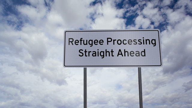 Highway road sign with the words refugee processing straight ahead written on it with a time-lapse clouds background.