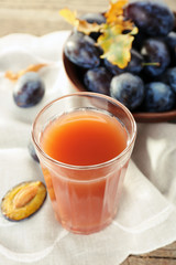 Plum Juice in a glass with fresh fruits