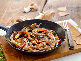 Fried oyster mushroom on a frying pan.