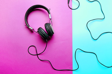Black headphones on purple-blue background