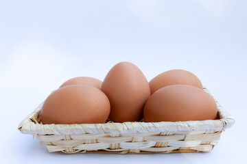  Egg in basket wicker on white background,raw egg