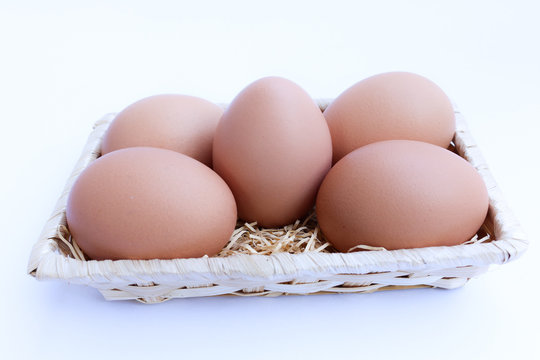  Egg in basket wicker on white background,raw egg