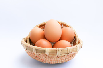 Egg in basket wicker on white background,raw eggs