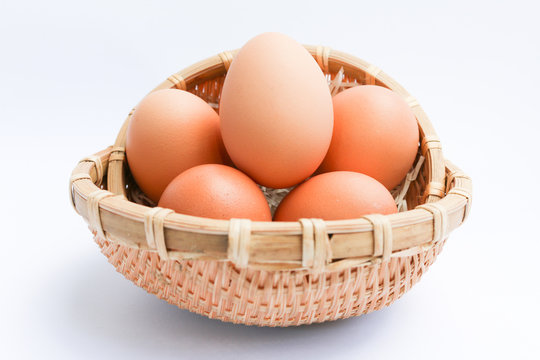  Egg in basket wicker on white background,raw eggs