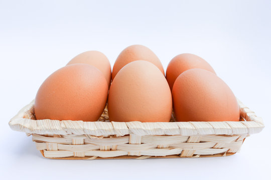  Egg in basket wicker on white background,raw eggs