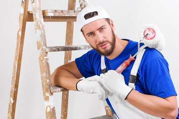 painter in white dungarees, blue t-shirt