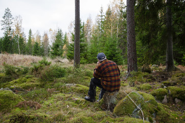 Man on a stump in the forest
