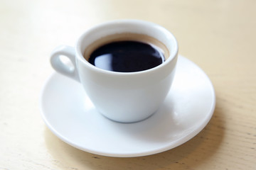 Cup of tasty coffee on table