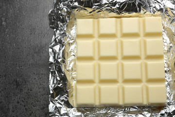 White Chocolate bar in foil  on gray background