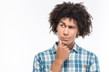 Fototapeta na wymiar Pensive afro american man with curly hair looking away