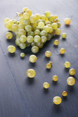 Juicy green grapes, on wooden background