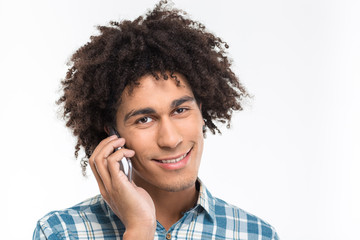 Afro american man with curly hair talking on the phone