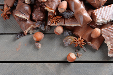 Chocolate sweets with powder on wooden background