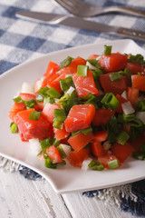 Salted salmon salad with vegetables close-up. Vertical
