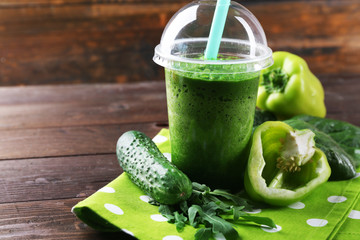 Fresh vegetable juice on wooden background
