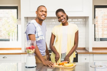 Young casual couple making fruits 