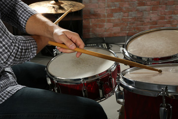 Fototapeta na wymiar Musician playing the drums closeup