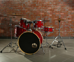 Fototapeta na wymiar Drum set on brick wall background