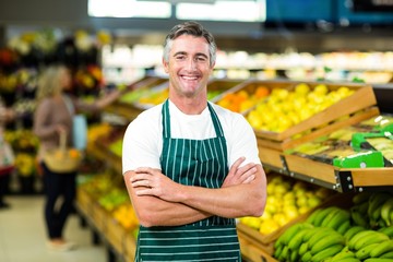 Portrait of a handsome seller with arm crossed 