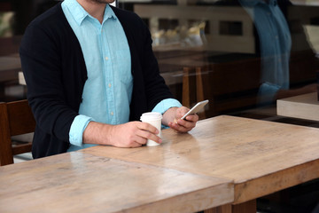 Businessman having lunch and working in a cafe, close-up