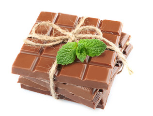 Milk chocolate bar with bow on color wooden background