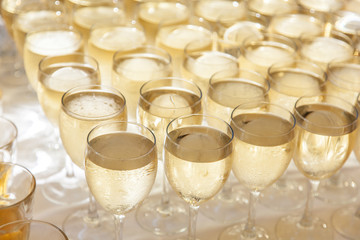 Raw of glasses filled with cold champagne.