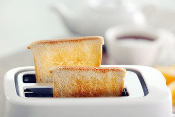 A couple of crusty toasts in the toaster, close-up © Africa Studio