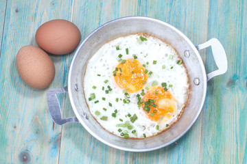 Egg in pan on wood table