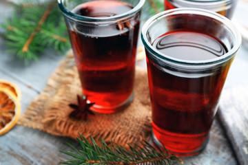 Tasty mulled wine and spices, on blue wooden background, close-up
