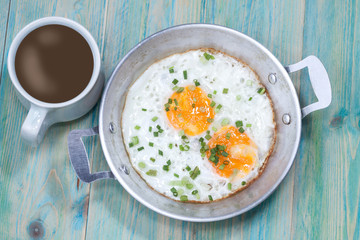 Egg in pan on wood table