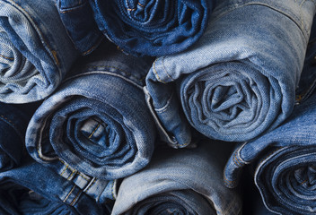 background of a stack rolled jeans