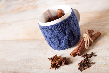 Mulled wine with spices on wooden table