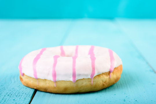 White And Pink Donut On Blue Background