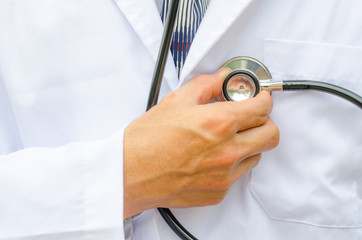 Close up male doctor's hand checking his own heart