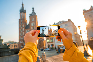 Vrouwelijke handen fotograferen met het oude stadscentrum van de mobiele telefoon in Krakau