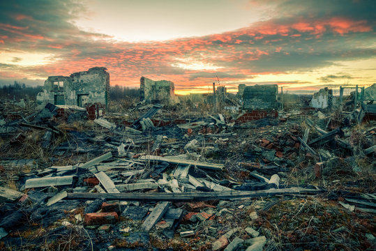 Apocalyptic landscape.The remains of destroyed houses at sunset