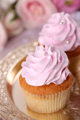 Tasty cupcakes on bright background