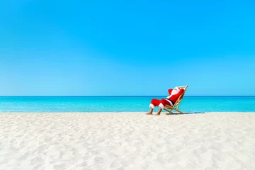 Christmas Santa Claus resting on sunlounger at ocean sandy tropical beach © EMrpize