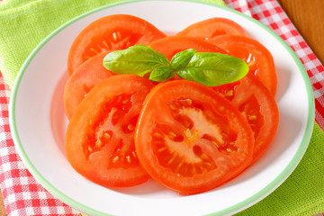 fresh tomato slices on plate