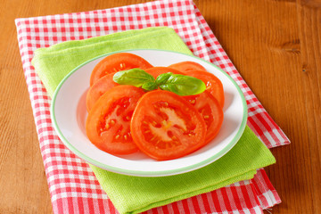 fresh tomato slices on plate